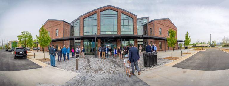 people outside a new building