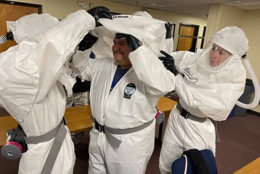 people in hazmat suits