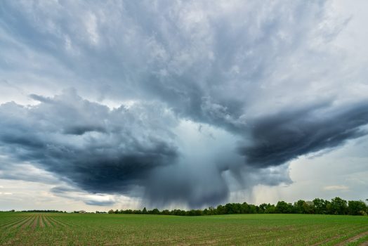 storm approaching over a field of grass
