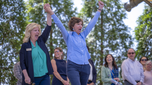 two women on stage cheering