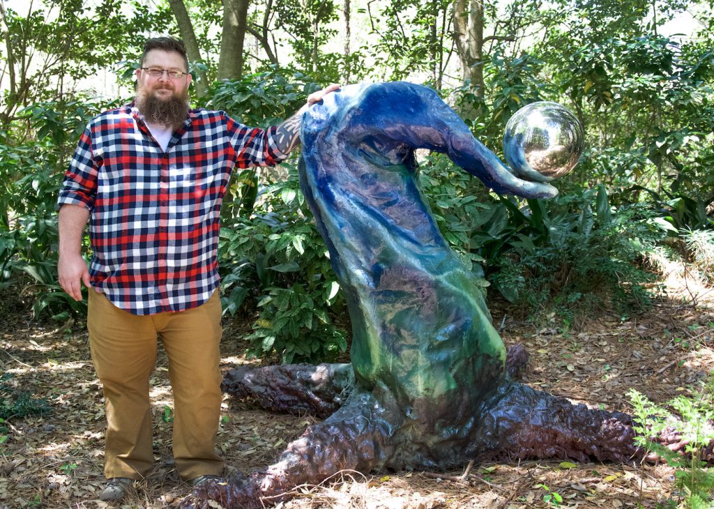 artist with sculpture