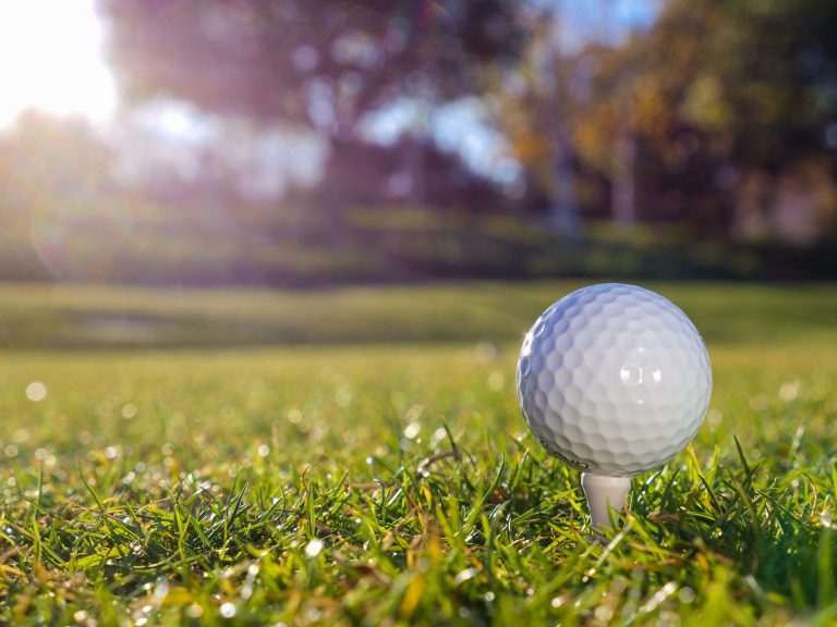 a golf ball sitting on a tee