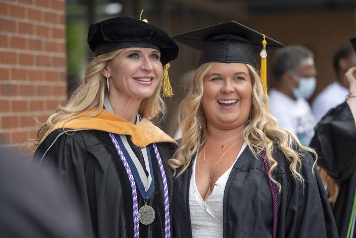 two women in graduation gowns