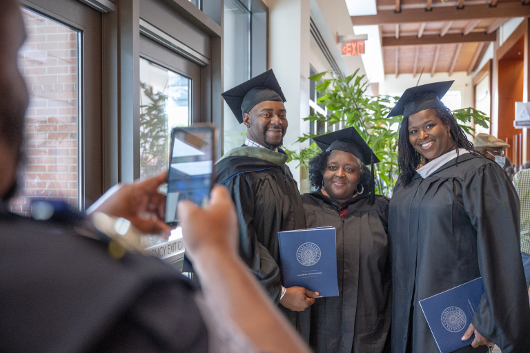 man photographing graduates