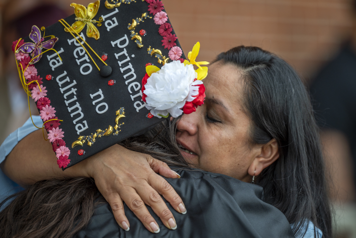 woman hugging graduate