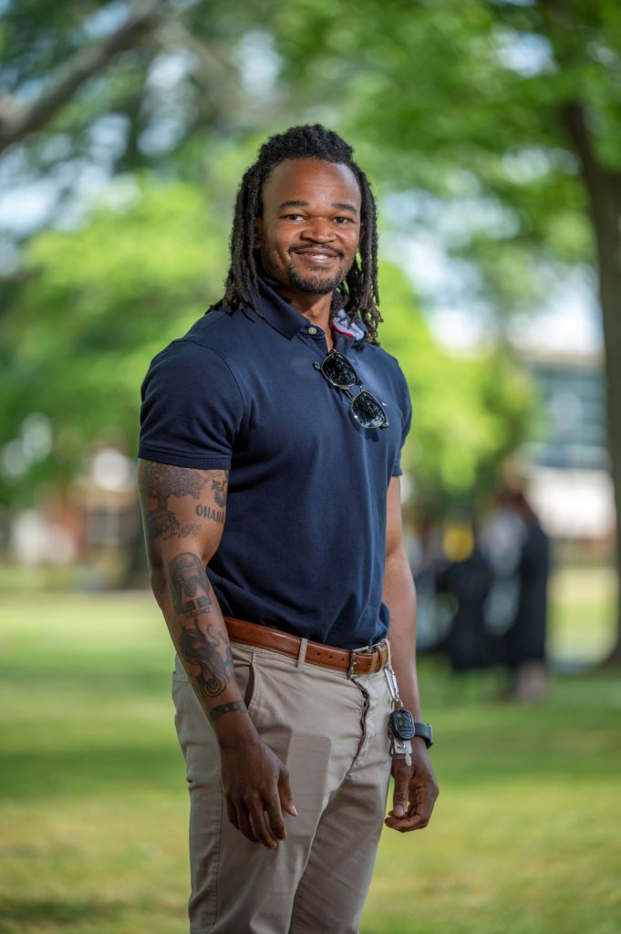 man in blue collared shirt standing outside