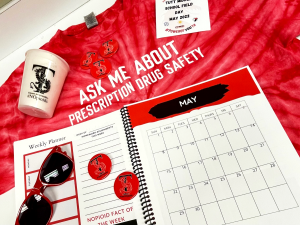 shirt, cup, sunglasses, calendar, stickers on table