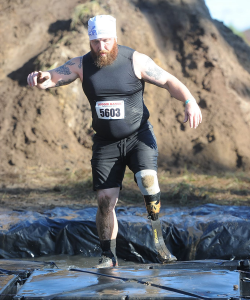 man running obstacle course