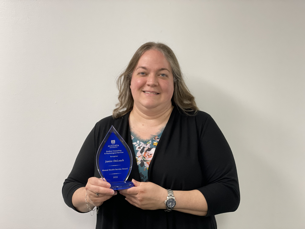 woman holding award