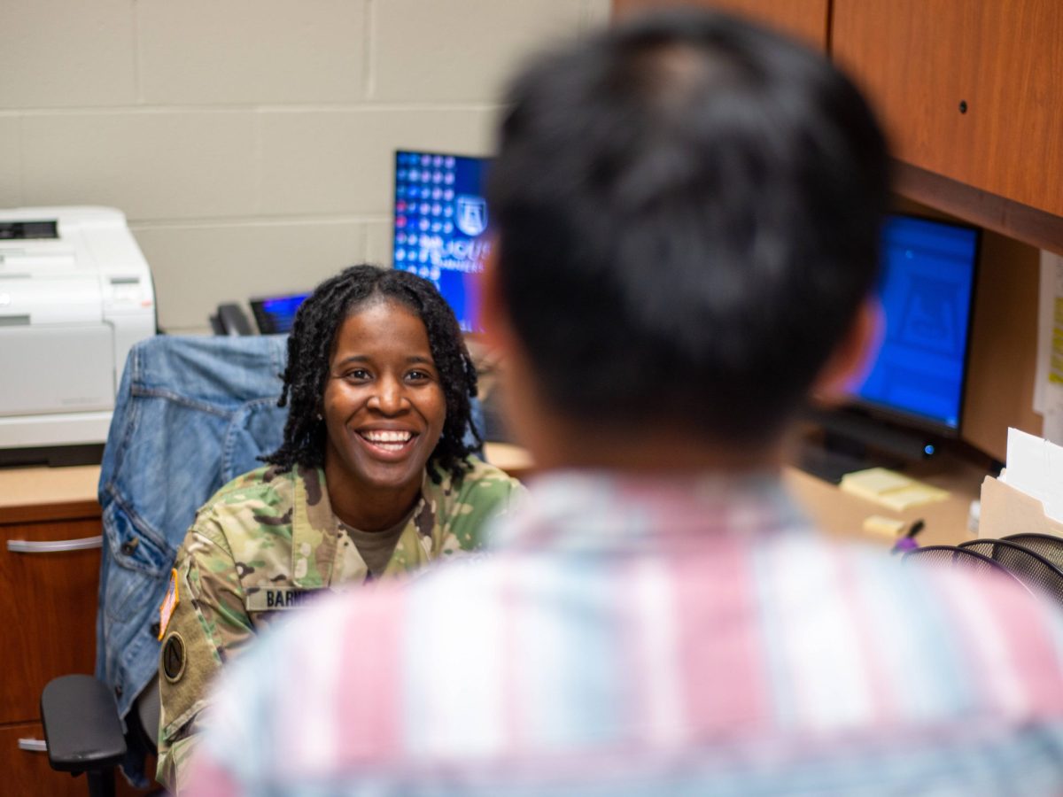 Photo of Lt. Barnes talking to student