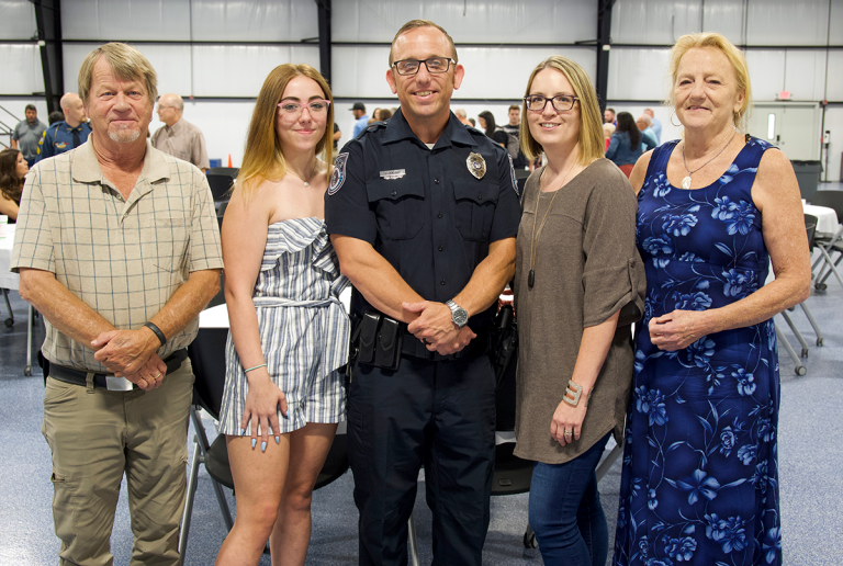 five family members standing