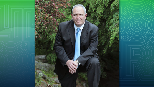 man in suit with hands together