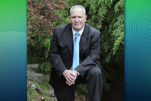 man in suit with hands together