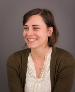 woman in brown cardigan smiling