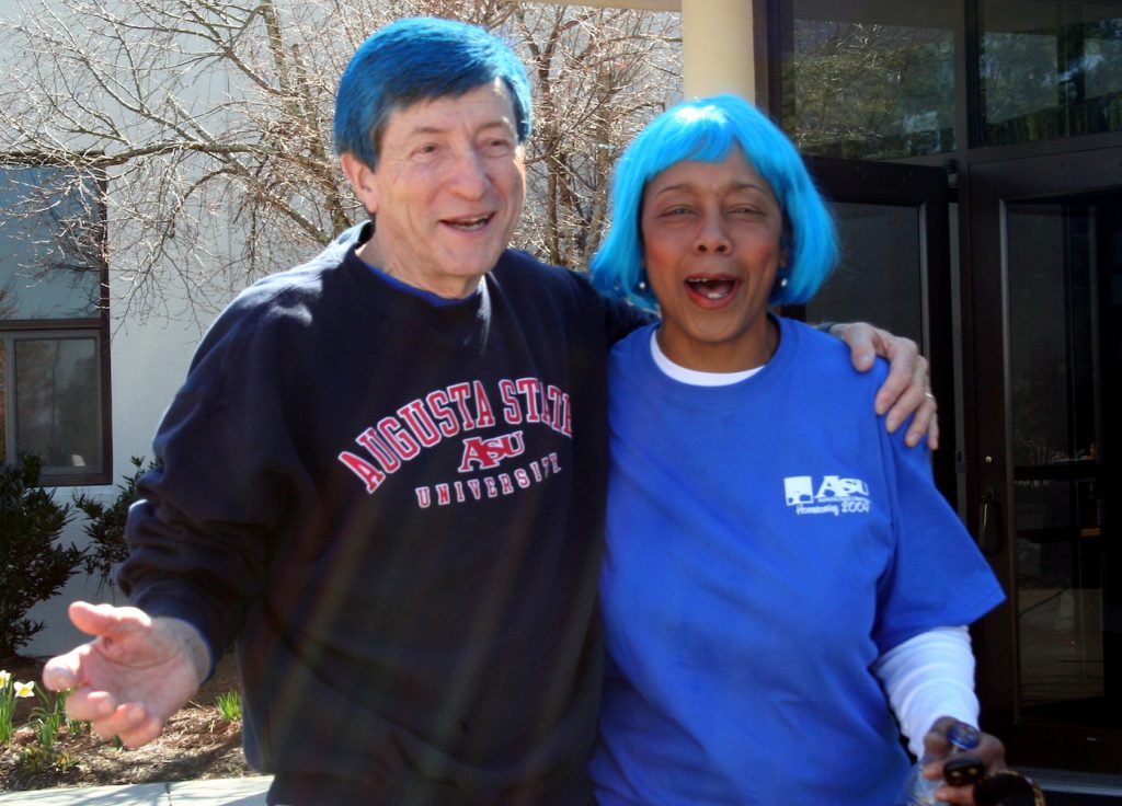 Two people standing with blue hair