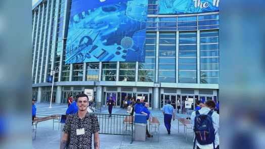 student standing in front of a convention center