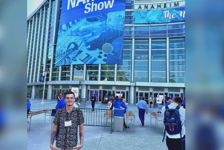 student standing in front of a convention center