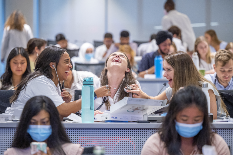 3 women laughing, using stethoscopes