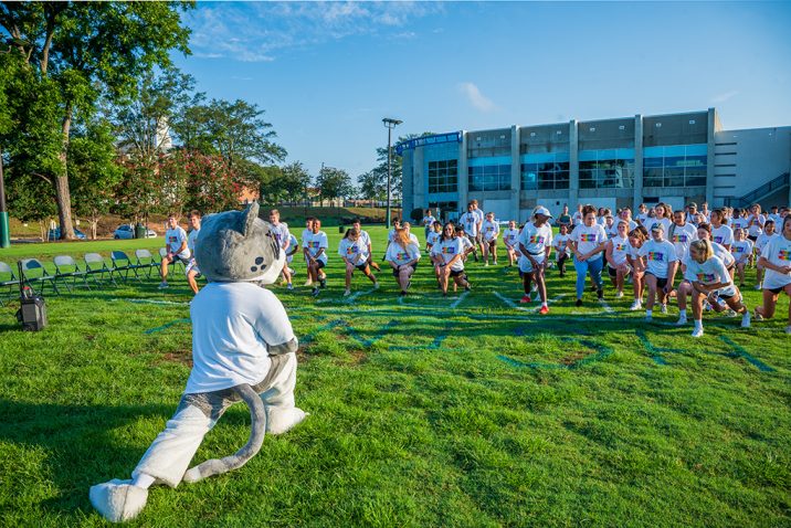 Students stretching with mascot