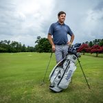 Man with golf clubs