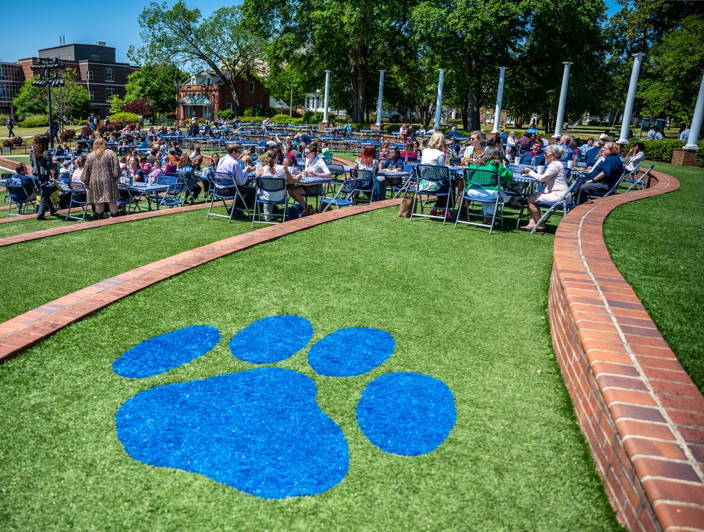 Paw print painted on ground, people in background