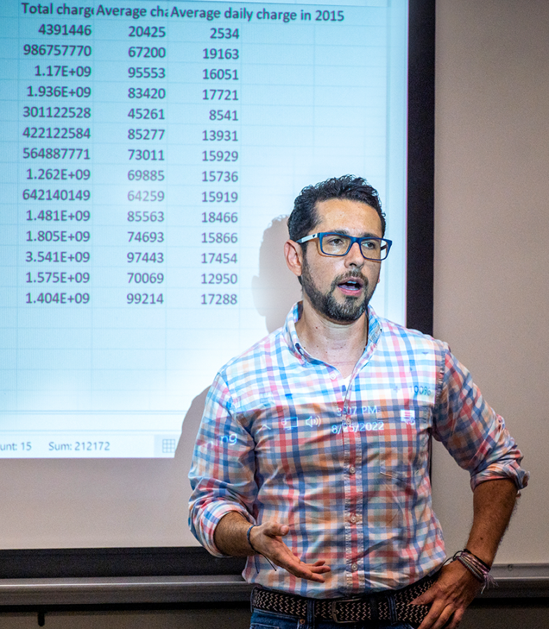 Man stands in front of a presentation.