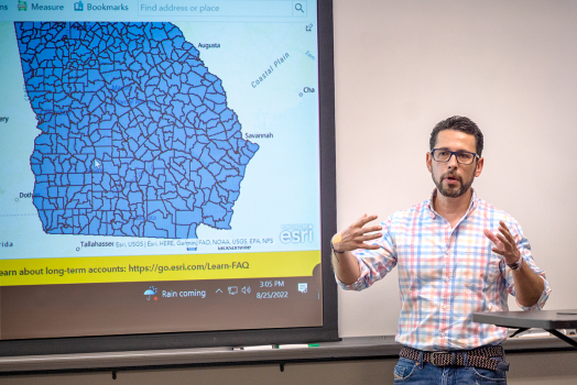 man standing in front of map