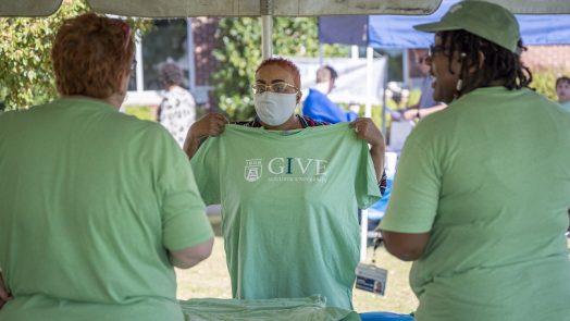 three women in green campaign tshirts