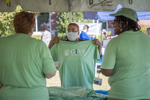 three women in green campaign tshirts