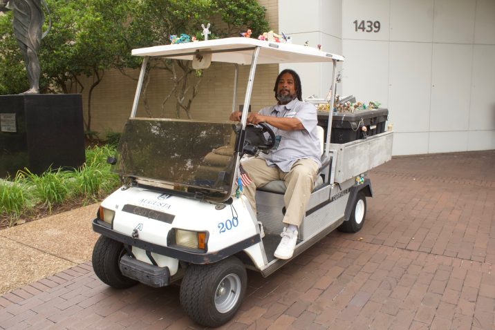 man sitting in his decorated golf cart