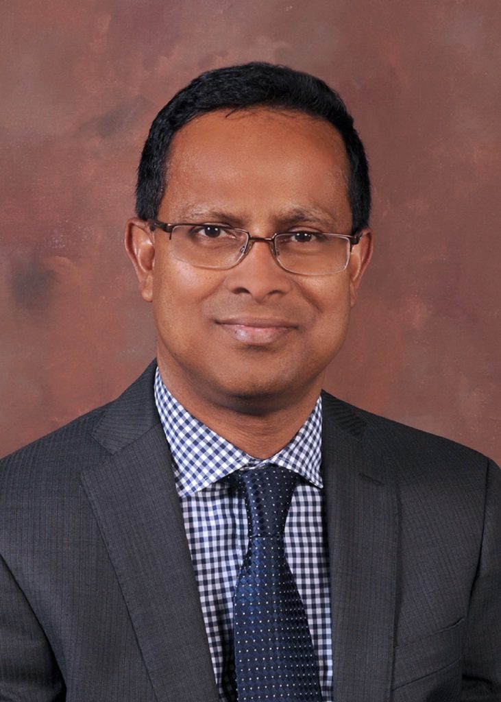 man in gray suit smiling