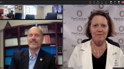 Man in office and woman in white coat on split screen Zoom call
