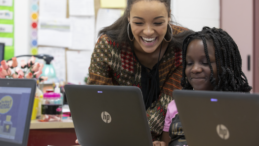 woman teaching girl