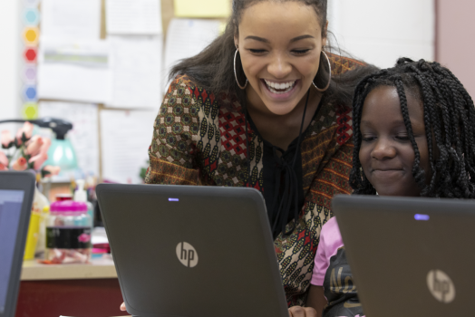 woman teaching girl