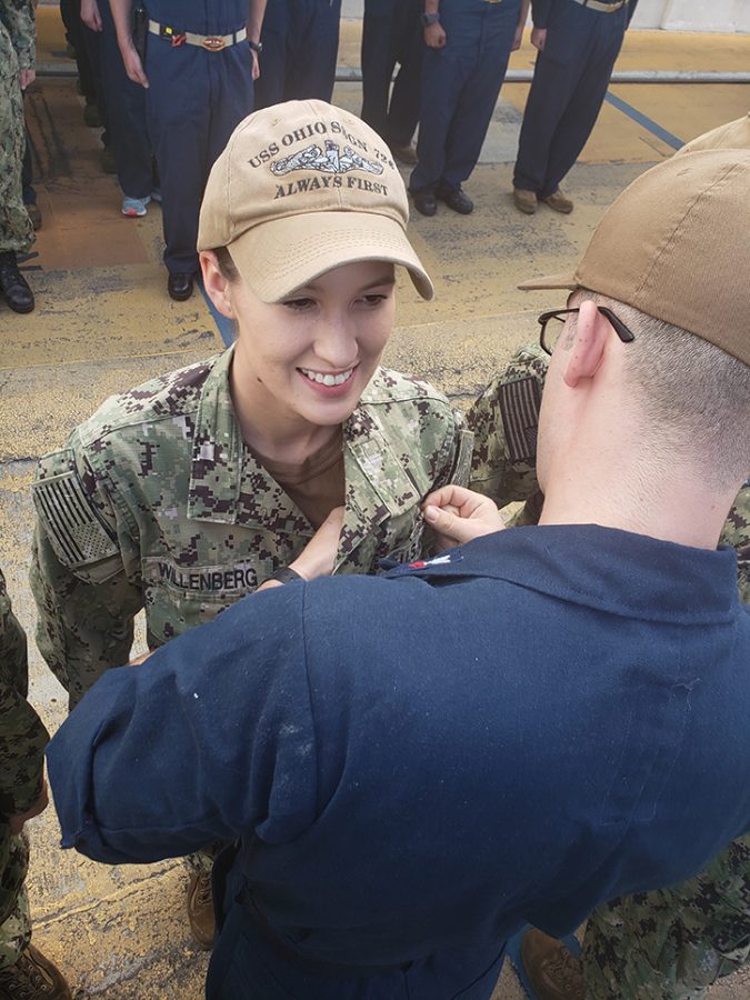 Man pinning woman in uniform