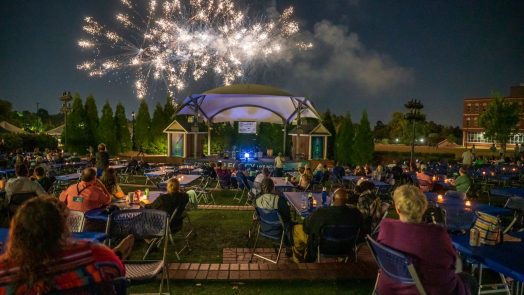 fireworks exploding over an amphitheater