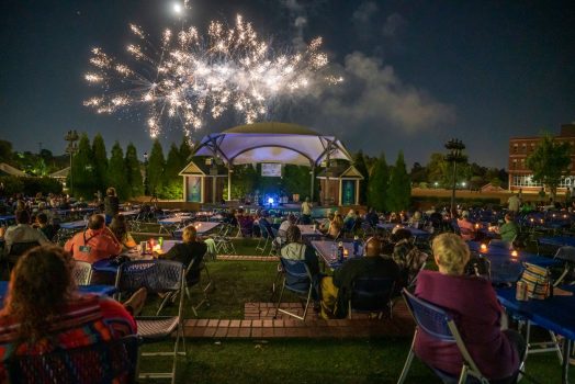 fireworks exploding over an amphitheater