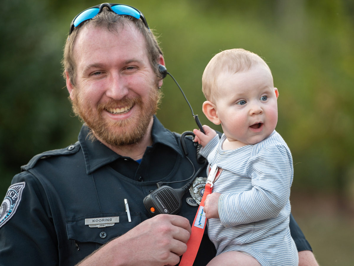 policeman holding baby
