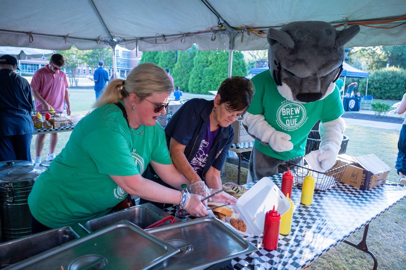 Augustus, Augusta University's mascot, helping hand out food