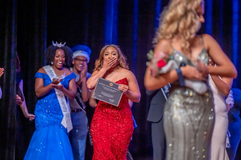 woman on stage looking surprised