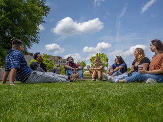 people smiling on the grass