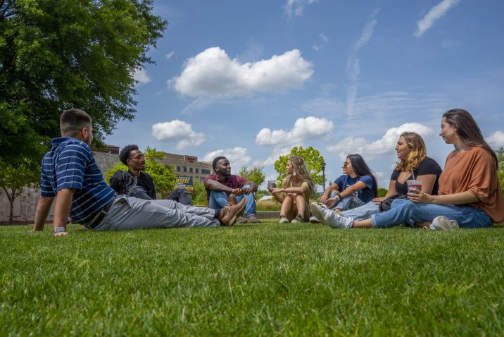 people smiling on the grass