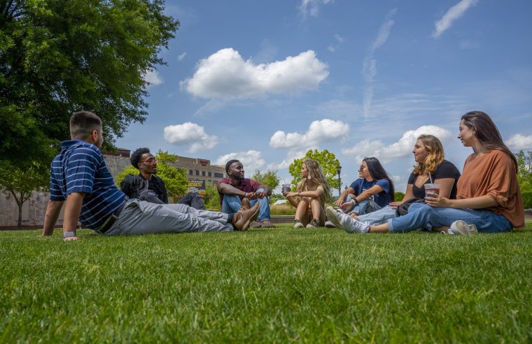 people smiling on the grass
