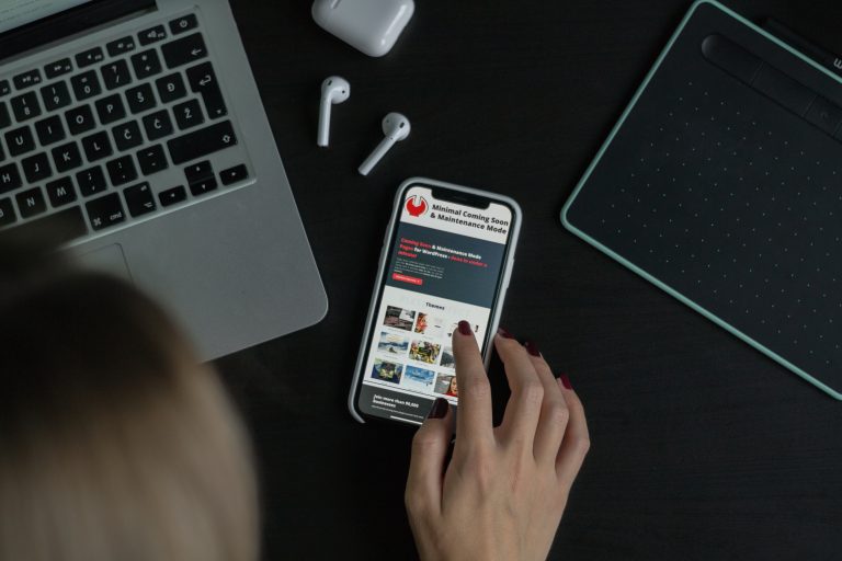 A person's hand using a cell phone