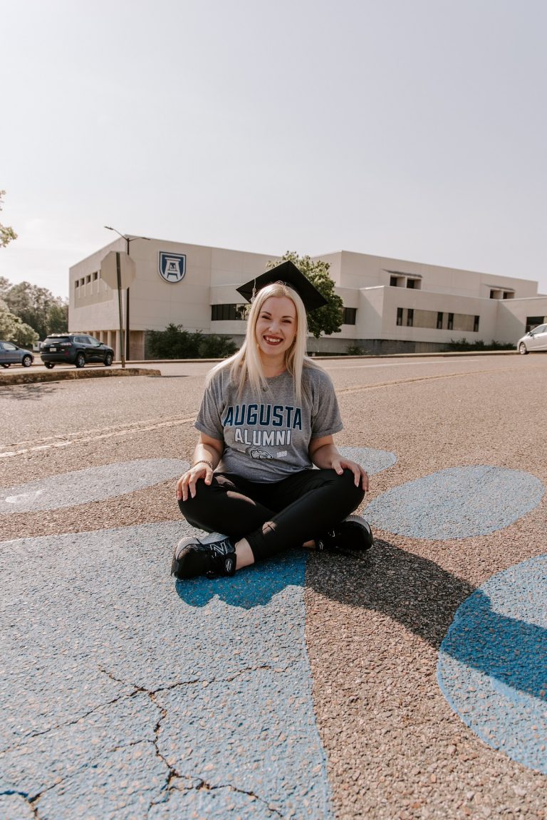 woman sitting outside in front of a building