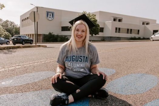 woman sitting outside in front of a building