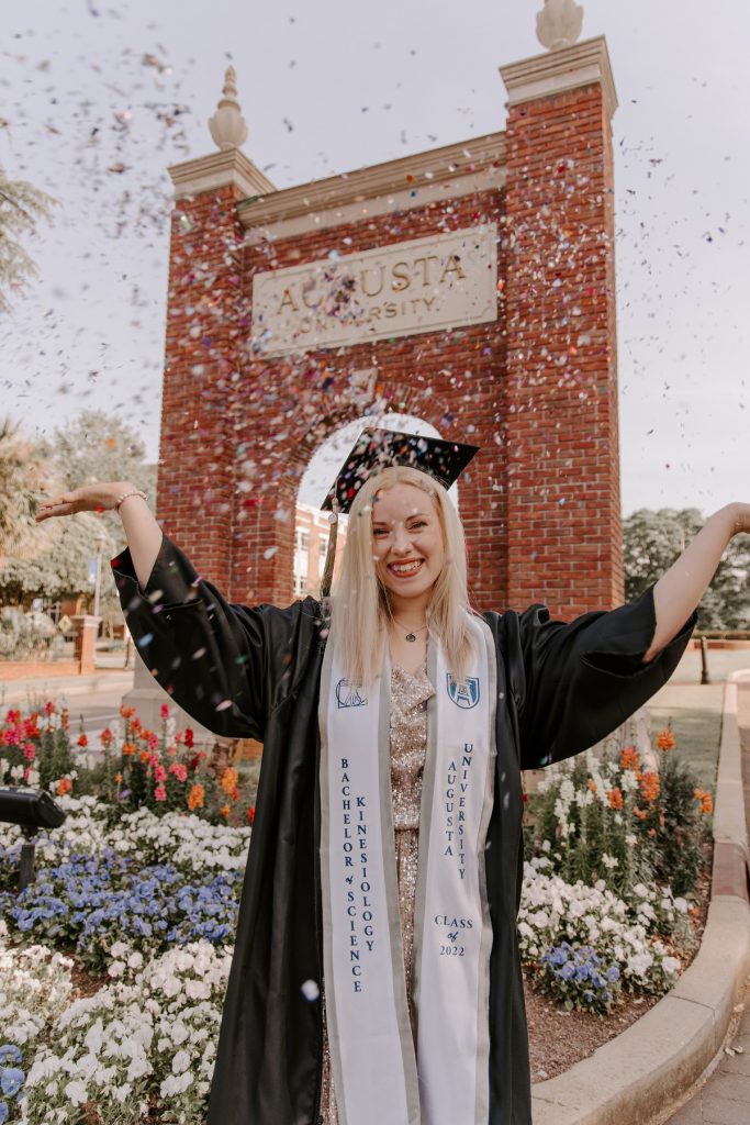 woman standing in front of Augusta University sign smiling