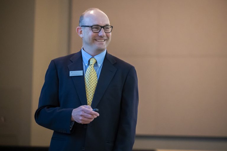 man in suit presenting