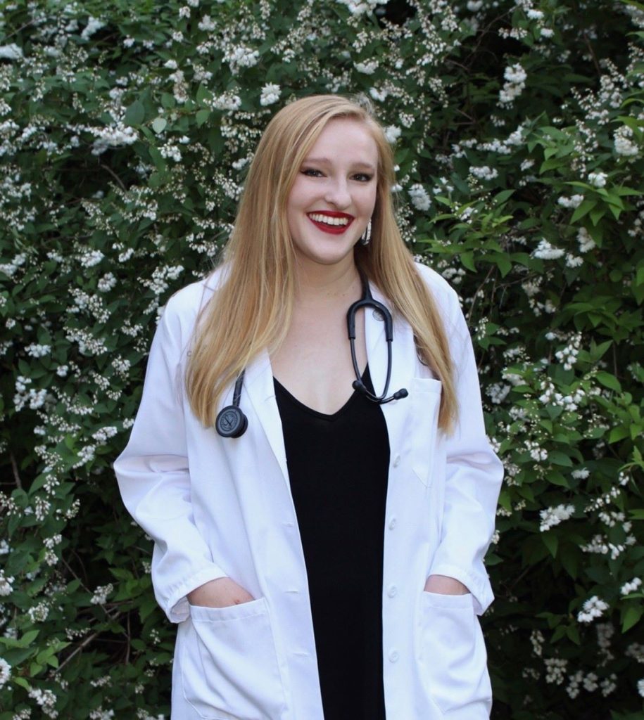 woman in white coat standing outside