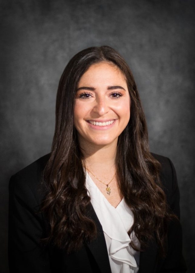 woman wearing black blazer, smiling